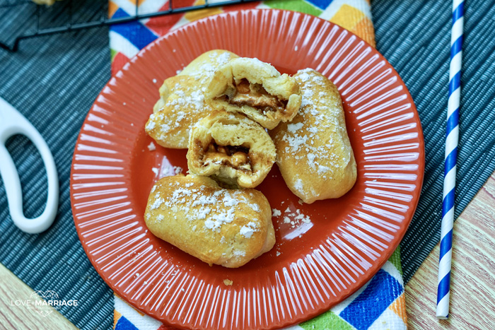 Deep Fried Snickers coated in powdered sugar are melt-in-your-mouth amazing. I'm obsessed with the caramel and chocolate oozing out of the doughy bun.