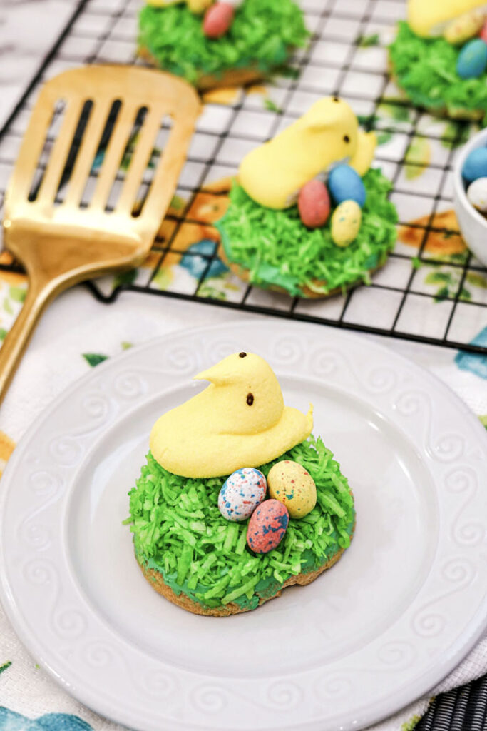 Easter cookies topped with a yellow Peep chick, coconut green "grass" and Robin's egg candies. Adorable and super easy to make.