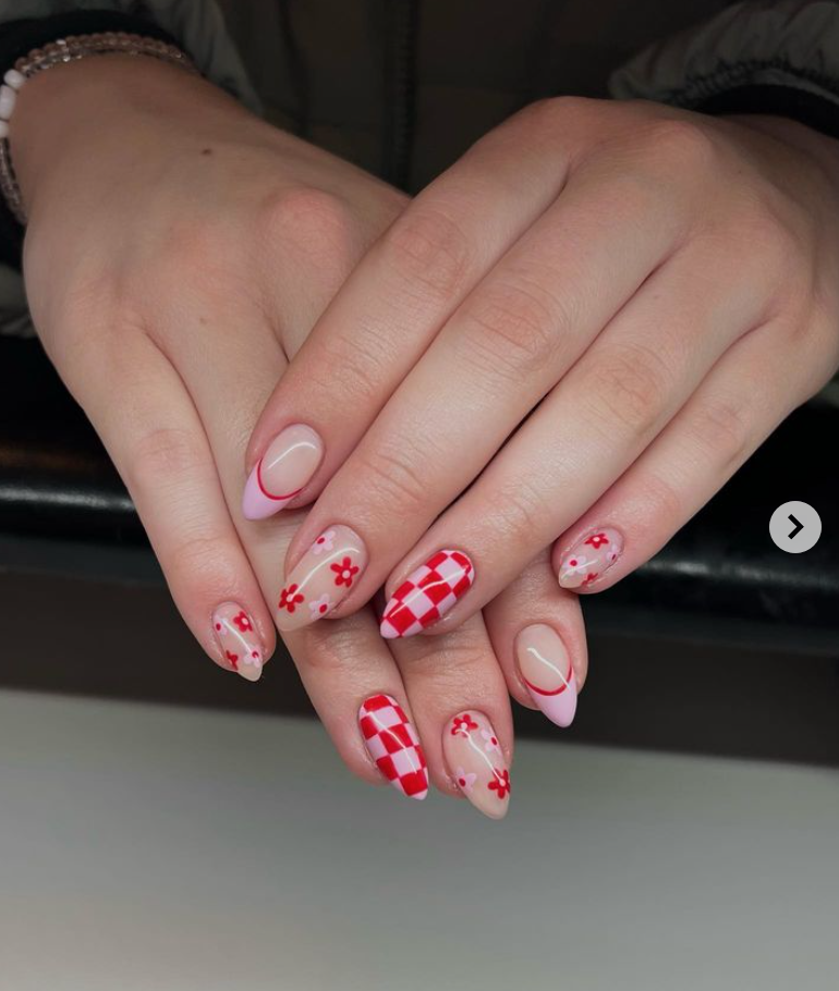 This spring nail inspiration with pink and red has daisies, colorful french tips and checkerboard.